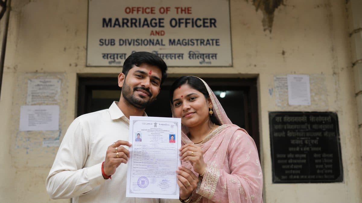 Couple with their marriage certificate outside the marriage officer's office